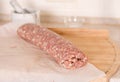 Raw meat roll over the kitchen Royalty Free Stock Photo