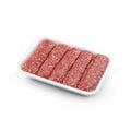 Raw meat sausages in caserola isolated on white background. Meat food, top view Royalty Free Stock Photo