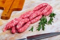 Raw meat sausages for frying on wooden desk Royalty Free Stock Photo