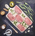 Raw Meat set Pork steaks with herbs and spices on a white cutting board wooden rustic background top view Royalty Free Stock Photo