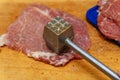 Raw meat sliced for cooking with meat hammer Royalty Free Stock Photo