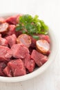 Raw meat with smoked sausages on plate Royalty Free Stock Photo