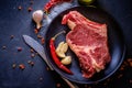 Raw meat steak entrecote on the plate with spice on the dark tab Royalty Free Stock Photo