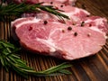 Raw meat, steak on a wooden Board. Spices, garlic, rosemary, peppers. Ready for cooking and roasting. Royalty Free Stock Photo