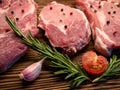 Raw meat, steak on a wooden Board. Spices, garlic, rosemary, peppers, tomato. Ready for cooking and roasting. Royalty Free Stock Photo