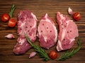 Raw meat, steak on a wooden Board. Spices, garlic, rosemary, peppers, tomato. Ready for cooking and roasting. Royalty Free Stock Photo