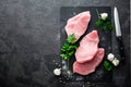 Raw meat, turkey steaks on black background, top view Royalty Free Stock Photo