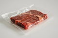 Raw meat in vacuum packaging on a white table. Royalty Free Stock Photo