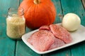 Raw meat, whole pumpkin, onion and rice with pepper mill Royalty Free Stock Photo