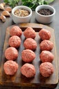 Raw meatballs on the cutting board