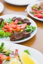 Raw meatballs made with Turkish bulgur on a white serving plate, cigkofte