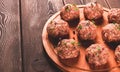 Raw meatballs, with micro greenery, on a cutting board, homemade, rustic, no people,