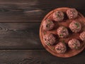 Raw meatballs, with micro greenery, on a cutting board, homemade, rustic, no people,