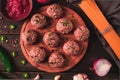 Raw meatballs, with micro greenery, with spices and ingredients, on a wooden table, homemade, rustic, no people,