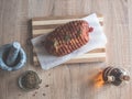 Raw meatloaf on table. Cooked spicy pork meat roulade prepared to roast, marinated with spices and herbs on black slate plate. Royalty Free Stock Photo