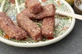 raw mici or mititei romanian traditional dish , on a ceramic plate Royalty Free Stock Photo