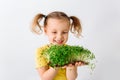 Raw microgreens broccoli sprouts in child hands, healthy eating concept