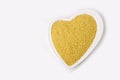 Raw millet a heart shaped plate on white background. Healthy breakfast. Organic and vegetarian food. Porridge and cereal concept. Royalty Free Stock Photo