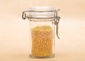 Raw millet in jar and on brown background Royalty Free Stock Photo