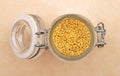 Raw millet in jar and on brown background Royalty Free Stock Photo