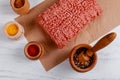 Raw minced meat beef with various spices on a wooden board Royalty Free Stock Photo