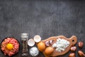 Raw minced meat with egg yolk, wooden cutting board on wooden background