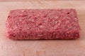 Raw minced meat roll on a wooden chopping board Royalty Free Stock Photo