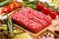 Raw minced meat with vegetables on wooden board Royalty Free Stock Photo