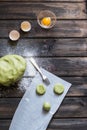 Raw mint and orange chip cookies on wooden table. Color dough. Mint cookies. Orange cookies. Process of baking. Homemade bakery.