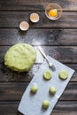 Raw mint and orange chip cookies on wooden table. Color dough. Mint cookies. Orange cookies. Process of baking. Homemade bakery.