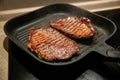 Raw minute steak of marbled beef in a grill pan Royalty Free Stock Photo