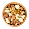 Raw mixed nuts in wooden bowl over white Royalty Free Stock Photo