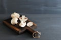 Raw Mushrooms whole and chopped on a wooden background