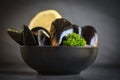 Raw Mussels with herbs lemon on bowl and dark background - Fresh seafood shellfish on ice in the restaurant or for sale in the Royalty Free Stock Photo