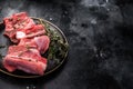Raw mutton cut rib chops, fresh lamb meat with herbs for grilling. black background. top view Royalty Free Stock Photo