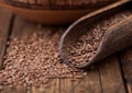 Raw natural organic linseed flax-seed in wooden spoon on wooden background. Healthy omega 3 product