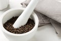 Raw, natural, unprocessed black pepper peppercorns in mortar Royalty Free Stock Photo