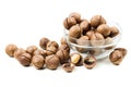 Raw not peeled whole macadamia nuts with shelled kernels in glas Royalty Free Stock Photo