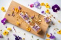 raw nut bars with edible flowers on top Royalty Free Stock Photo