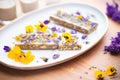 raw nut bars with edible flowers on top Royalty Free Stock Photo