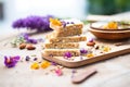 raw nut bars with edible flowers on top Royalty Free Stock Photo