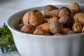 Raw Nuts in Shells in a white Serving Bowl