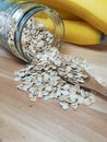 Raw oatmeal is scattered on the desk Royalty Free Stock Photo