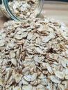 Raw oatmeal is scattered on the desk Royalty Free Stock Photo