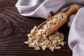 Raw oatmeal on a wooden rustic background