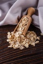 Raw oatmeal on a wooden rustic background