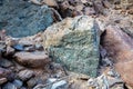 Raw ore of copper, green stones and rocks containing copper in old mining area, Hajar Mountains, United Arab Emirates