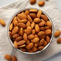 Raw Organic Almonds in a Bowl on a gray background, top view Royalty Free Stock Photo