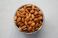 Raw Organic Almonds in a Bowl on a gray background, top view Royalty Free Stock Photo