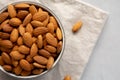 Raw Organic Almonds in a Bowl on a gray background, top view. Copy space Royalty Free Stock Photo